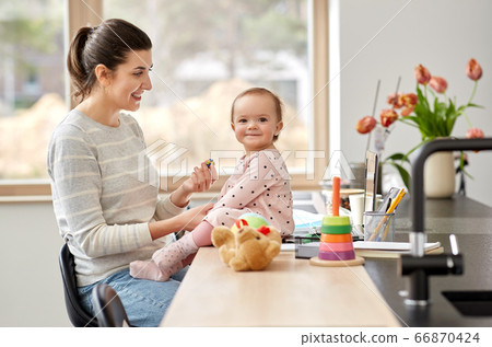 happy mother with baby working at home office happy mother with baby working at home office 66870424