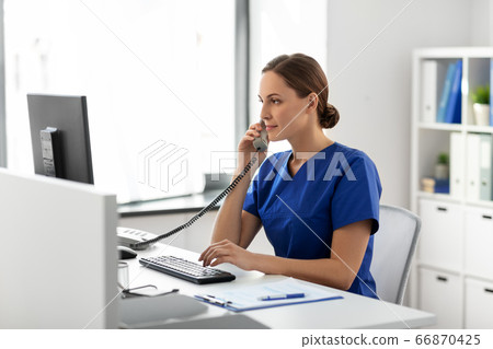 doctor with computer calling on phone at hospital doctor with computer calling on phone at hospital 66870425