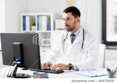 male doctor with computer working at hospital male doctor with computer working at hospital 66870456