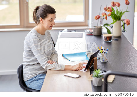 young woman with tablet pc working at home office young woman with tablet pc working at home office 66870519