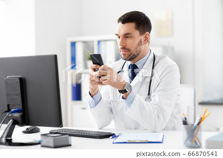 male doctor with smartphone at hospital male doctor with smartphone at hospital 66870541