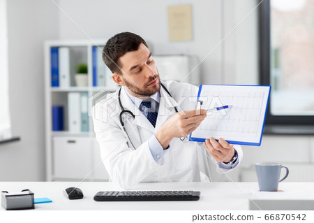 doctor with cardiogram having video call at clinic doctor with cardiogram having video call at clinic 66870542