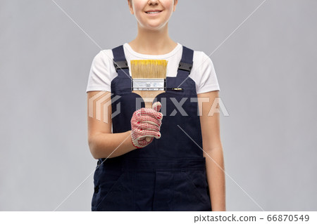 close up of painter or builder with paint brush close up of painter or builder with paint brush 66870549
