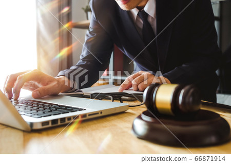 justice and law concept.Male judge in a courtroom on wooden table and Counselor or Male lawyer working in office. Legal law, advice and justice concept. justice and law concept.Male judge in a courtroom on wooden table and Counselor or Male lawyer working in office. Legal law, advice and justice concept. 66871914