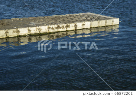White floating board on blue sea under sunlight White floating board on blue sea under sunlight 66872201