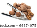 Walnuts with nutcracker 66874075
