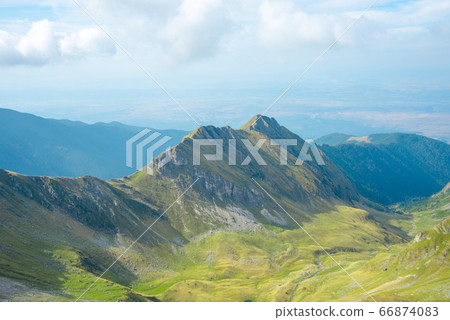 Breathtaking landscape in Carpathian mountains. With high green hills and rocks Breathtaking landscape in Carpathian mountains. With high green hills and rocks 66874083