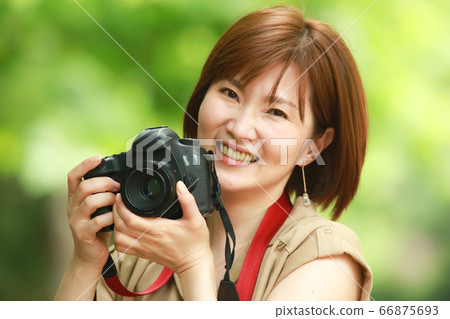 A woman taking a picture 66875693