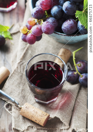 Red wine and grape on the wooden table Red wine and grape on the wooden table 66875715