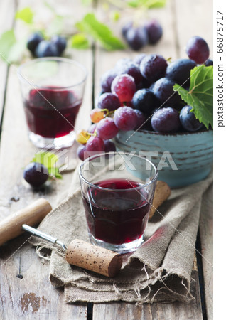Red wine and grape on the wooden table 66875717
