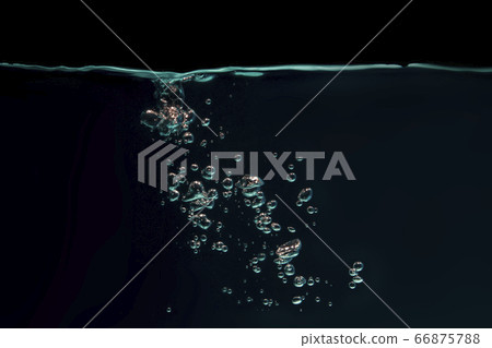 Green bubbles floating in a black background 66875788