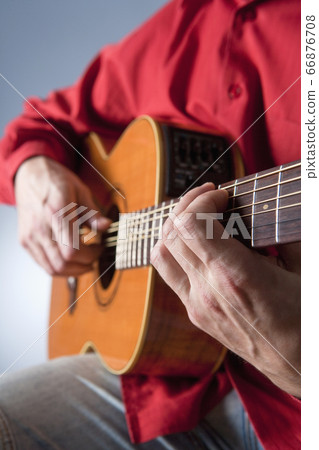 Guitar player playing acoustic guitar Guitar player playing acoustic guitar 66876708