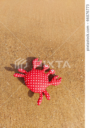 Handmade fabric toy crab on sandy background. Summer time and vacation concept. Handmade fabric toy crab on sandy background. Summer time and vacation concept. 66876773