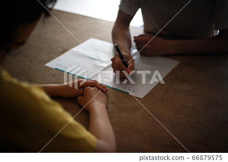 A couple filling out a divorce report A couple filling out a divorce report 66879575