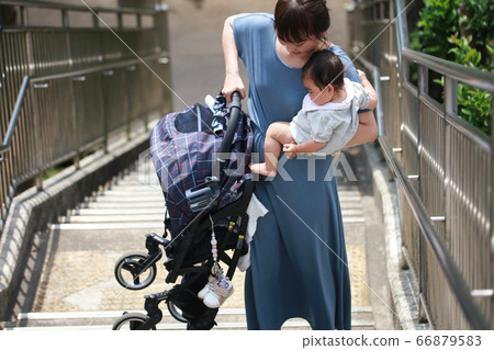 Mother lifting stroller and climbing stairs Mother lifting stroller and climbing stairs 66879583
