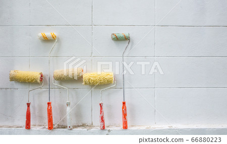 Many used paint rollers put on the background of Many used paint rollers put on the background of 66880223