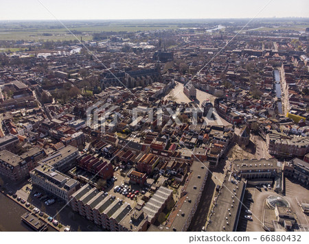 Aerial drone Photo of the Dutch City Gouda where gouda cheese is made. City center with lots of historical buildings and churches including the city hall and the cheese market Aerial drone Photo of the Dutch City Gouda where gouda cheese is made. City center with lots of historical buildings and churches including the city hall and the cheese market 66880432