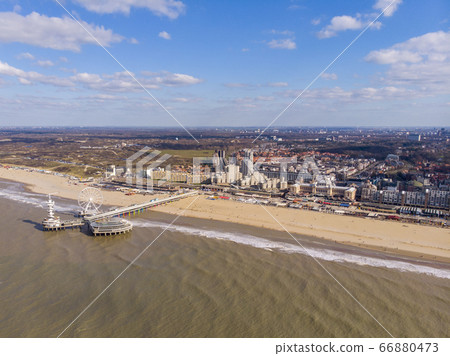 Pier with Ferris Wheel at Northern Sea Scheveningen Beach , located near the Hague city aerial drone footage. Popular Dutch beach resort Scheveningen With a clouds on the Sky in a day Pier with Ferris Wheel at Northern Sea Scheveningen Beach , located near the Hague city aerial drone footage. Popular Dutch beach resort Scheveningen With a clouds on the Sky in a day 66880473