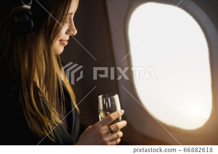 Attractive woman in private jet 66882618