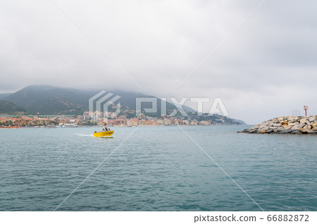 Yellow fishing boat sails in the harbor 66882872