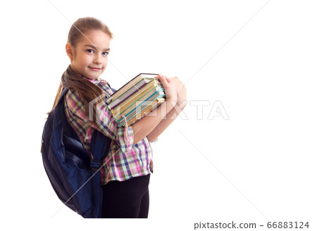 Schoolgirl holding bunch of books in her hands 66883124