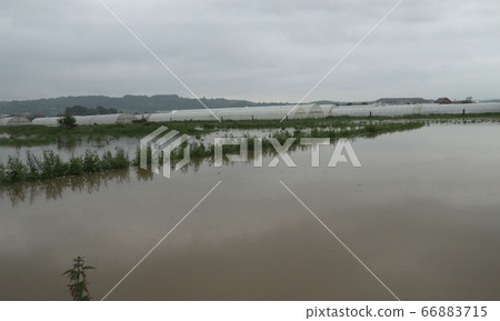 After hard rain cultivated fields are flooded by 66883715