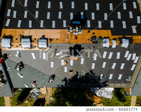 Roofer replace shingle that has been damaged and 66883774