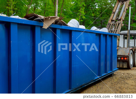 Truck loading a full recycling container trash Truck loading a full recycling container trash 66883813