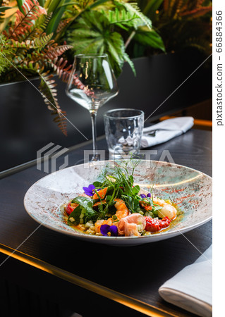Prawn salad view from above in a deep plate against the background Prawn salad view from above in a deep plate against the background 66884366