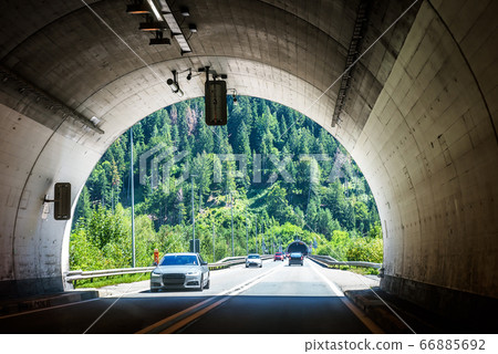 Road tunnel in Alpine mountains, Switzerland. Road tunnel in Alpine mountains, Switzerland. 66885692