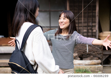 A mother welcoming her homecoming daughter A mother welcoming her homecoming daughter 66886289