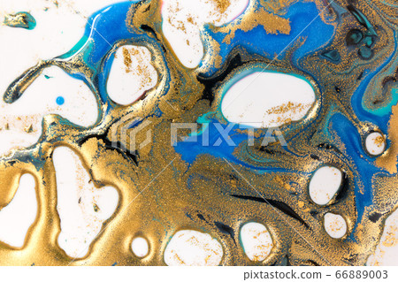 Gold and blue inks splattered on white paper background. Golden glitter Gold and blue inks splattered on white paper background. Golden glitter 66889003
