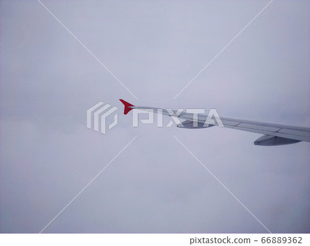 Plane wing in the middle of the cloud 66889362