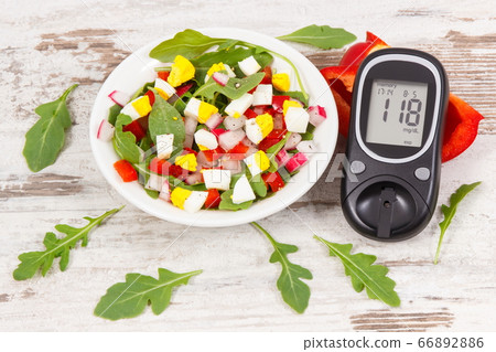 Glucometer with result of sugar level and fresh salad Glucometer with result of sugar level and fresh salad 66892886