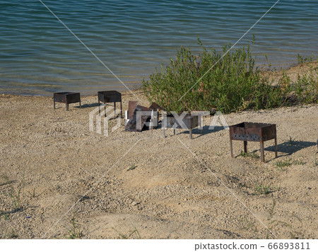 Iron barbecue. Left garbage of the lake. Iron barbecue. Left garbage of the lake. 66893811