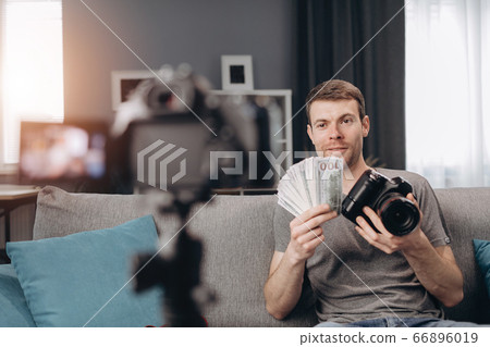 Happy bearded man filming new video for blog at home 66896019