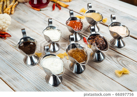 Variety of different sauces on the wooden table 66897756
