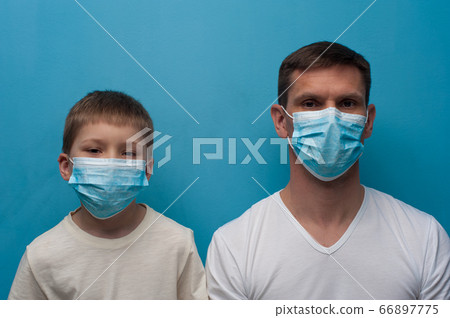 Caucasian father and son wearing protective medical mask. 66897775