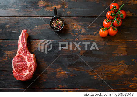 Cowboy beef steak, and spices with tomatoes on a 66898348