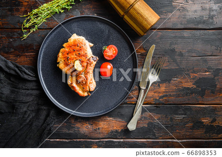 Dish of grilled pork chop with tomatoes top view Dish of grilled pork chop with tomatoes top view 66898353