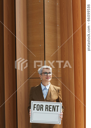 Businesswoman with placard outdoors Businesswoman with placard outdoors 66899586