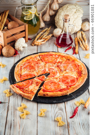 Margarita tomatoes pizza on the white wooden table Margarita tomatoes pizza on the white wooden table 66901881