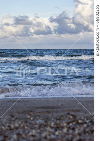 Sea waves, sandy beach and clouds Sea waves, sandy beach and clouds 66902255