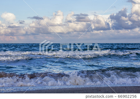 Sea waves, sandy beach and clouds 66902256