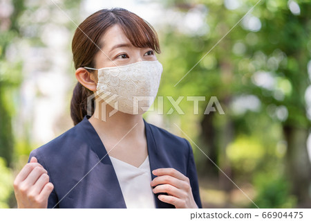 A young woman on the way to work wearing a fashionable lace mask A young woman on the way to work wearing a fashionable lace mask 66904475