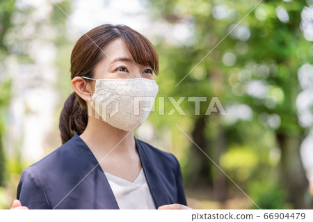 A young woman on the way to work wearing a fashionable lace mask 66904479