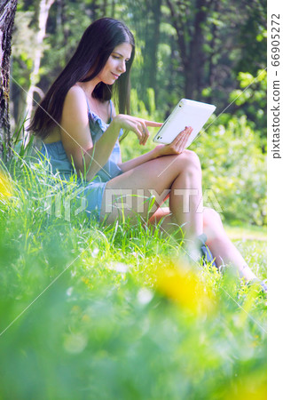 Woman using tablet outdoor Woman using tablet outdoor 66905272