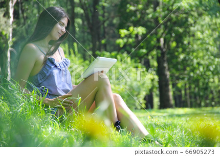 Woman using tablet outdoor Woman using tablet outdoor 66905273