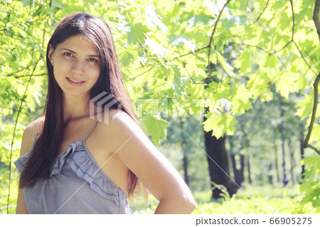 Woman in spring park Woman in spring park 66905275