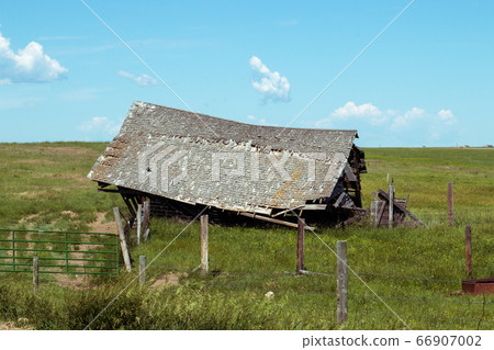 An old barn in a field An old barn in a field 66907002